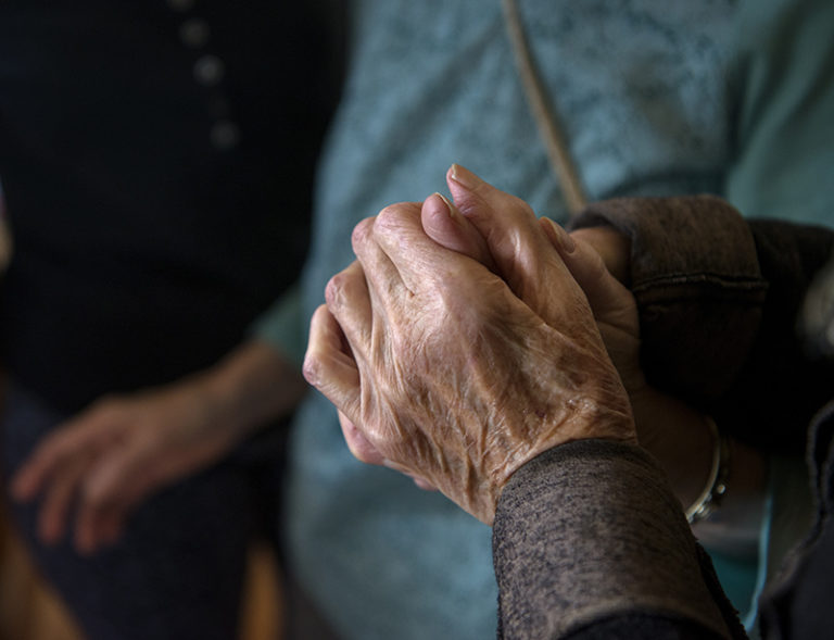 em022819f/jnorth/Jane Morrison, who suffers from memory loss, holds hands with Glenys Carl at her home in Santa Fe, Thursday February 28, 2019. Carl is trying to start Scott's House to help give care givers a break. (Eddie Moore/Albuquerque Journal)